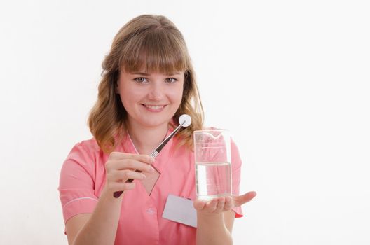 Pharmacist sitting at the table reading a thick handbook of medicines