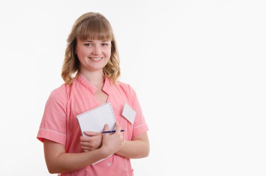 Portrait of a young pretty girl medical worker on a white background