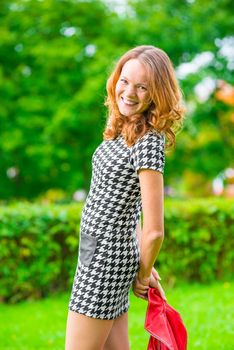 Portrait of a cheerful girl with red hair