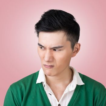 Funny facial expression, closeup Asian young man.