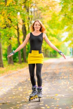 active young girl roller-skating in the autumn park