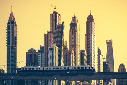 View of Dubai with subway and skycrapers at sunset. UAE