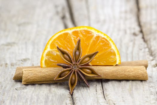 orange, cinnamon, anise on wooden bcakground