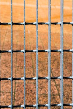 Red stone pavement behind steel bars background