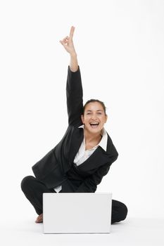 young beautiful businesswoman sitting in front of her laptop cheering