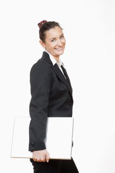 attractive young businesswoman standing with laptop computer smiling