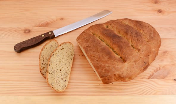Slices cut from a multi seed malted loaf with a sharp bread knife on a table