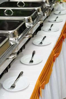 chafing dishes at table ready for wedding catering