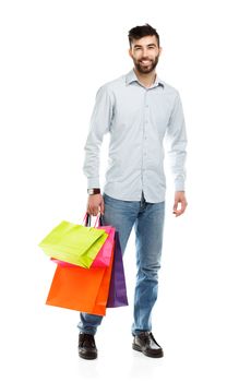 Handsome man holding shopping bags. Christmas and holidays concept