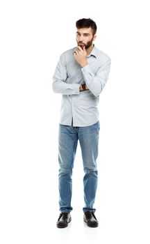 A young bearded man with a serious expression on his face isolated on white background