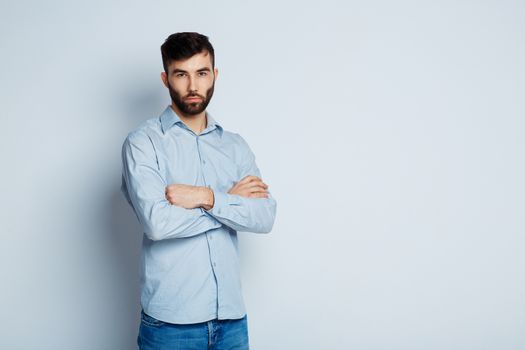 A young bearded man with a serious expression on his face