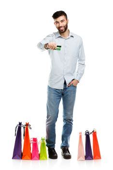 Handsome man with shopping bags and holding credit card. Christmas and holidays concept