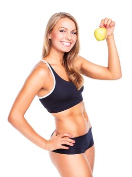 Young smiling girl holding green apple in hand. Fitness woman isolated on white background