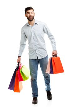 Handsome man holding shopping bags. Christmas and holidays concept