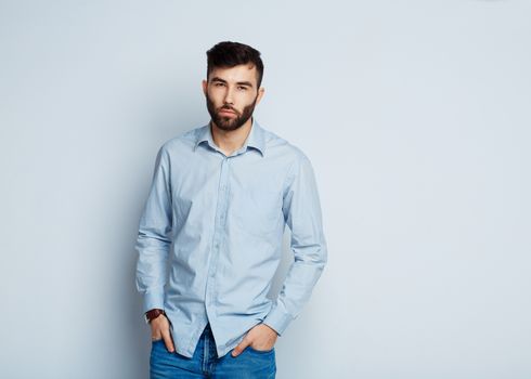 A young bearded man with a serious expression on his face