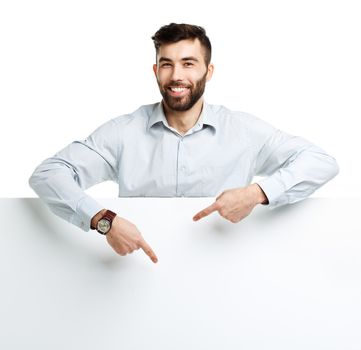 A young bearded man showing blank signboard, isolated over white background