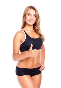 Young athletic girl with a finger up on white background