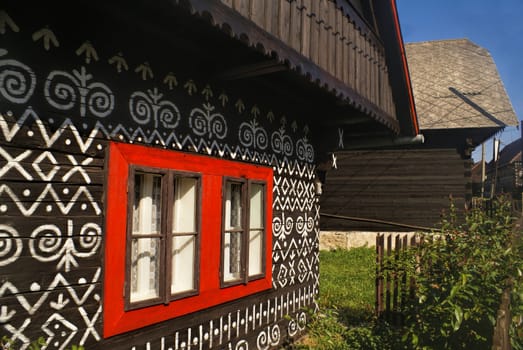 Painted facade of traditional wooden house in Slovakia in famous village of Cicmany