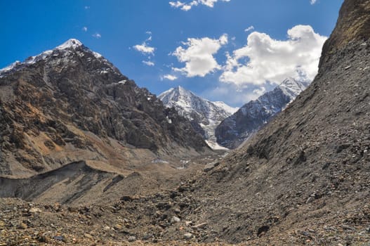 Lower parts of scenic Engilchek glacier with picturesque Tian Shan mountain range in Kyrgyzstan