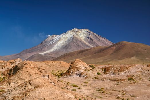 Picturesque volcano near salt planes Salar de Uyuni in bolivian desert, South America
