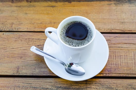 Coffee cup and water glass on a wooden table.