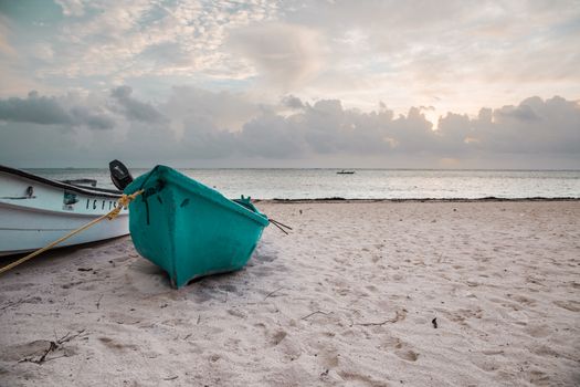 Boat on sandy Tropical Caribbean beach