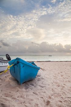 Boat on sandy Tropical Caribbean beach