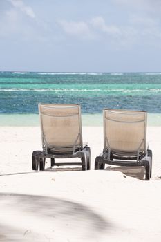 Sunbeds on Caribbean sandy Beach