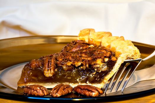 Pecan pie with fork on plate.