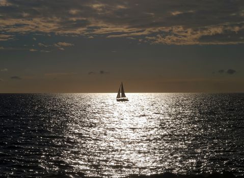 summer sundown and sailboat on the ocean