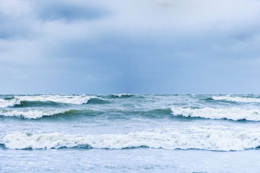 View of waterside with stormy waves