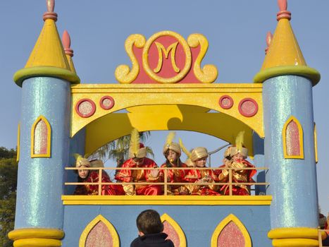 The Cavalcade of Magi, traditional parade of kings coaches in street, in Seville, Spain. The Magi (Melchior, Gaspar, and Baltasar) ride through the streets, as their page boys throw candies to children. 
