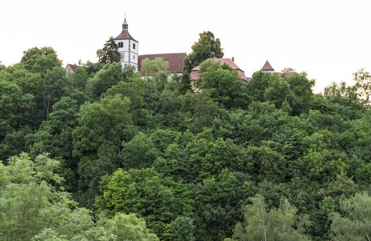 historical building in south west Germany  hidden behind trees. horizontal image