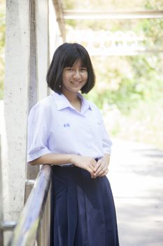 Asian schoolgirl smiling. And relax in the garden area.