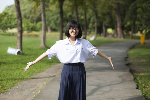 Girl smiling with happiness. On the path in the park.