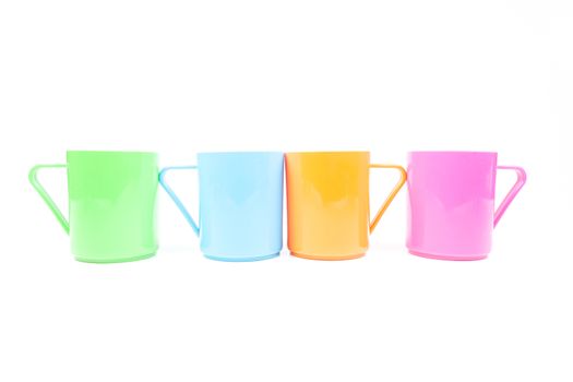 plastic cups colors. Colorful glass arranged in rows. Isolated white background