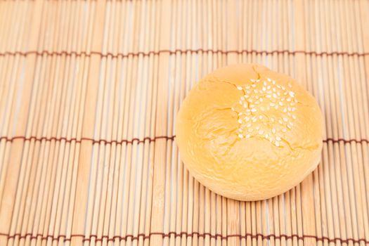 Bread sphere. A small white beans on top of bread. Placed on wood