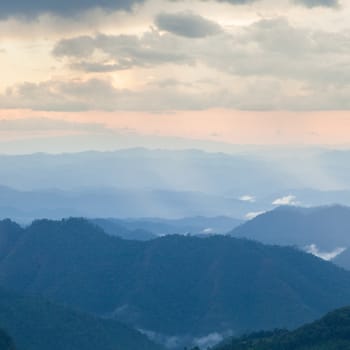 mist-shrouded mountains. High mountain complex. Fog in the morning and evening.