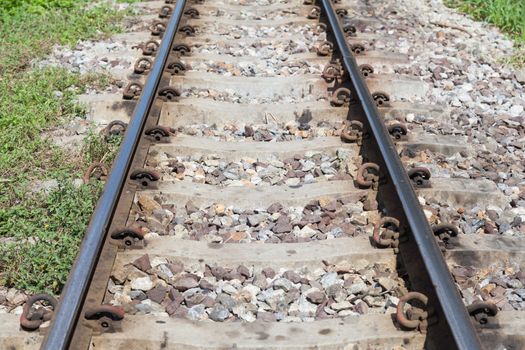 Railroad tracks. With iron bars and cement. A rock base of the tracks.