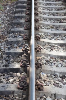 Railroad tracks. With iron bars and cement. A rock base of the tracks.