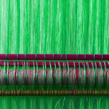 Handmade silk textile industry, silk scarf on a old machine (Vietnam), green