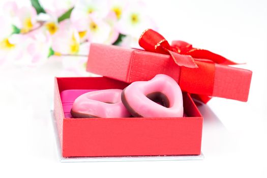 pink heart cookies for valentines day in red gift, on white background