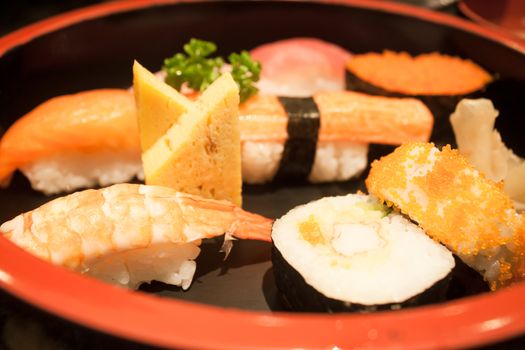 Closeup sushi set on black plate, stock photo