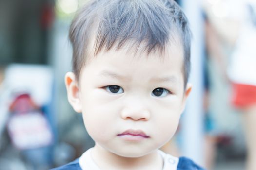 Little asian boy looking at camera , stock photo