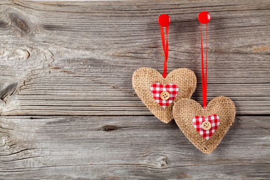 Heart shaped decoration made of wood, over wooden background