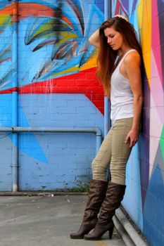 Young woman standing in front of a colorful background.