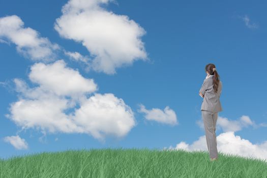Asian business woman standing on grassland and thinking with copyspace on heaven.