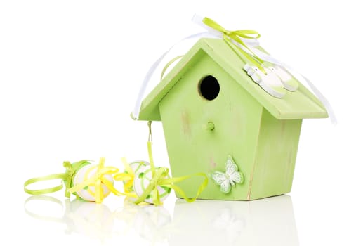 Easter eggs with birdhouse, on a white background