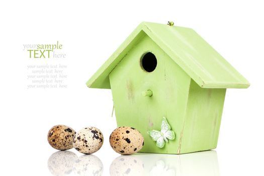 quail eggs with birdhouse, on a white background