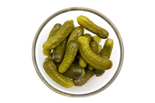 pickles on bowl on white background seen from above